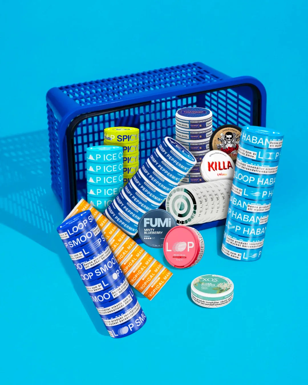 Assorted nicotine pouches products including cans and packages in a blue shopping cart